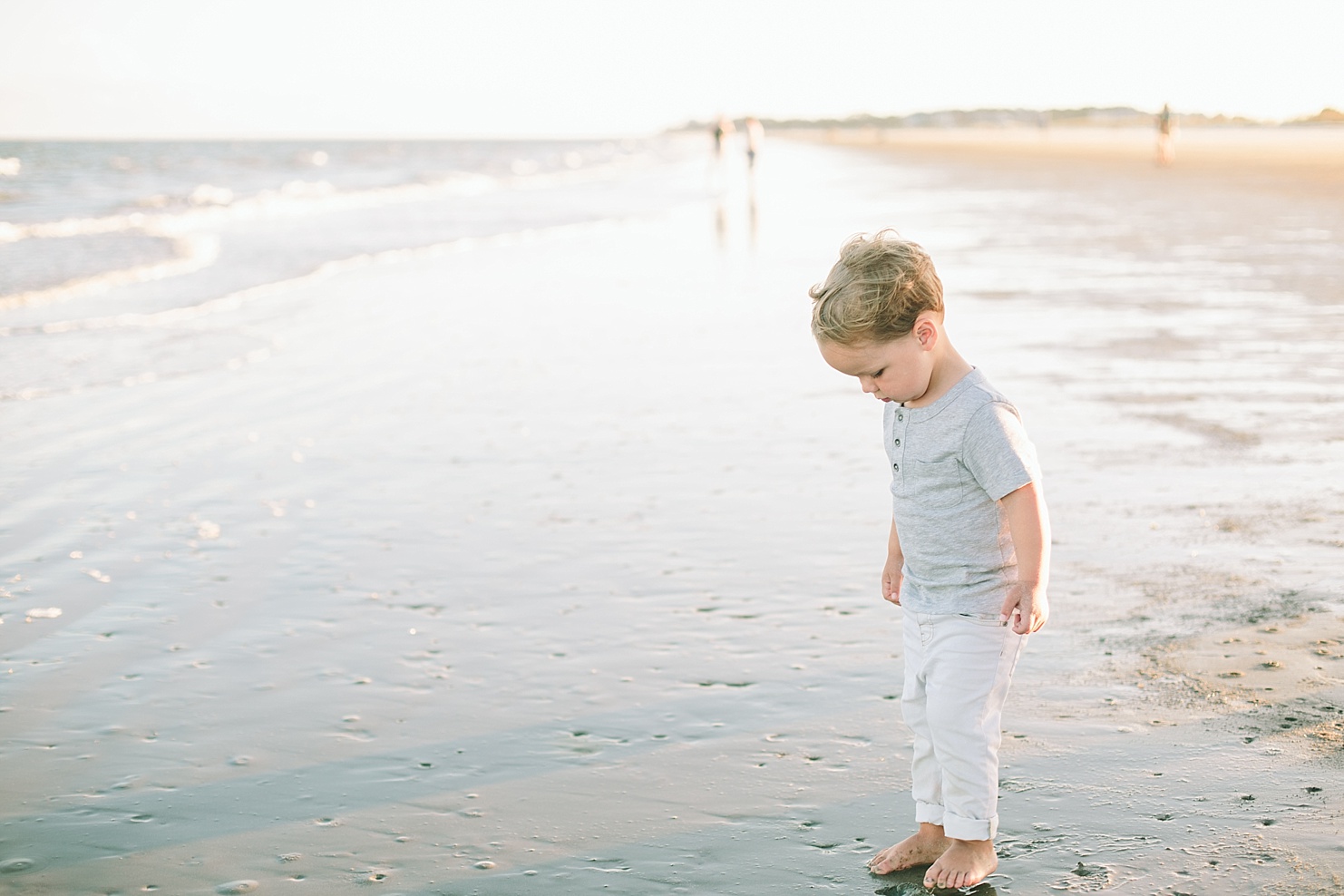 Little boy on beach at edge of water