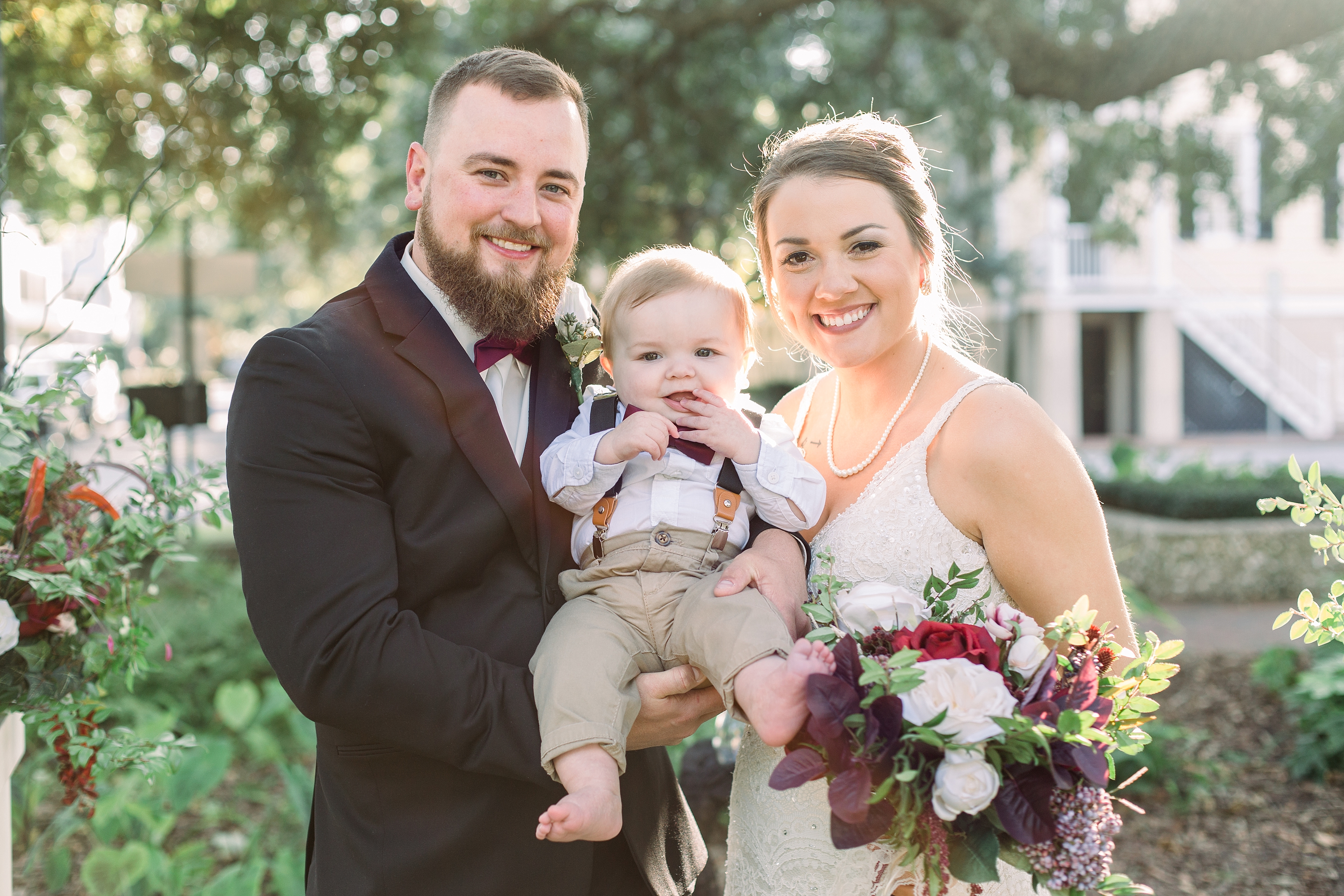 Bride and groom with their son on wedding day.